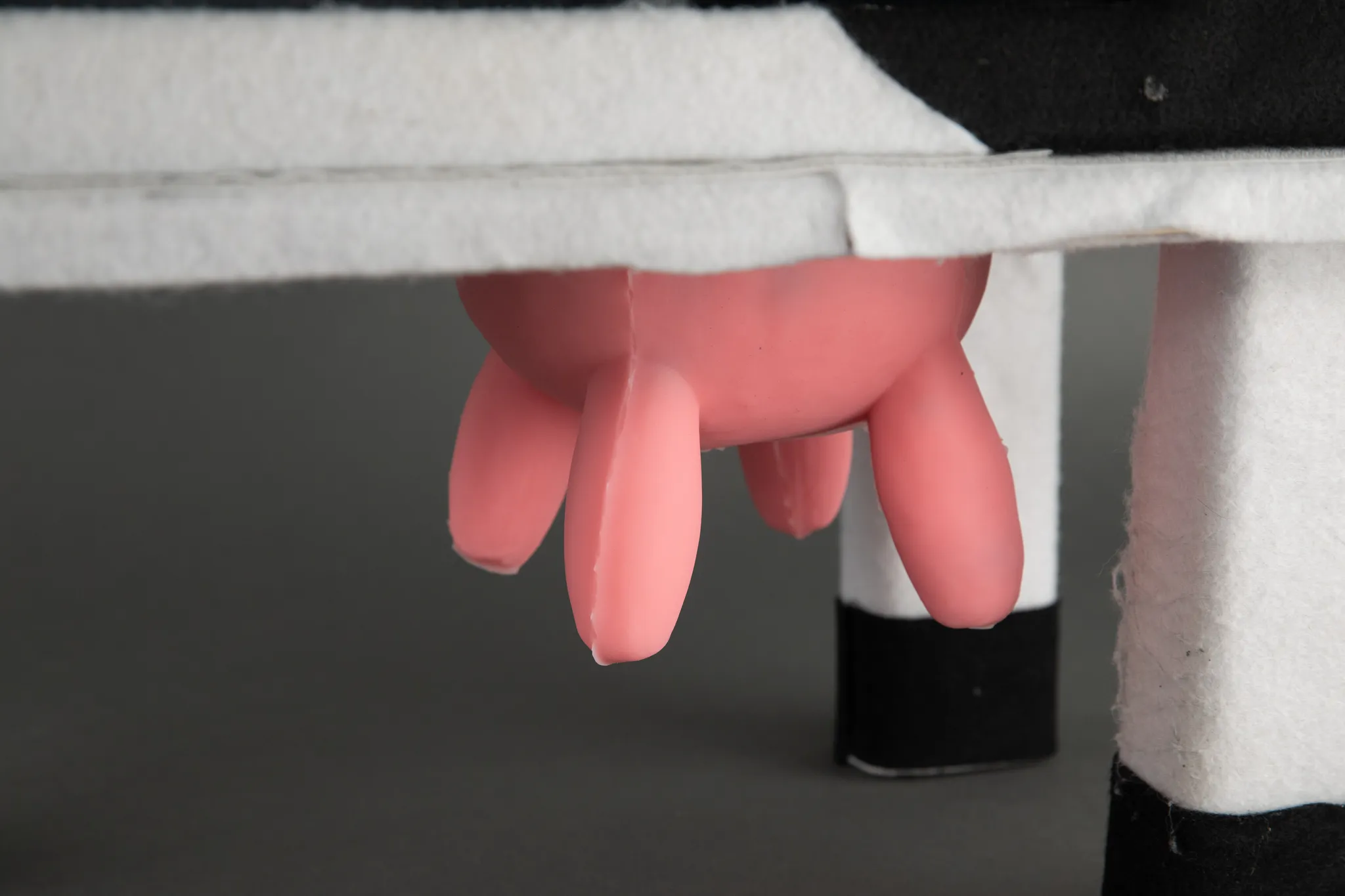 A photograph of a close up of a silicone udder for an arcade cabinet in the shape of a cow.