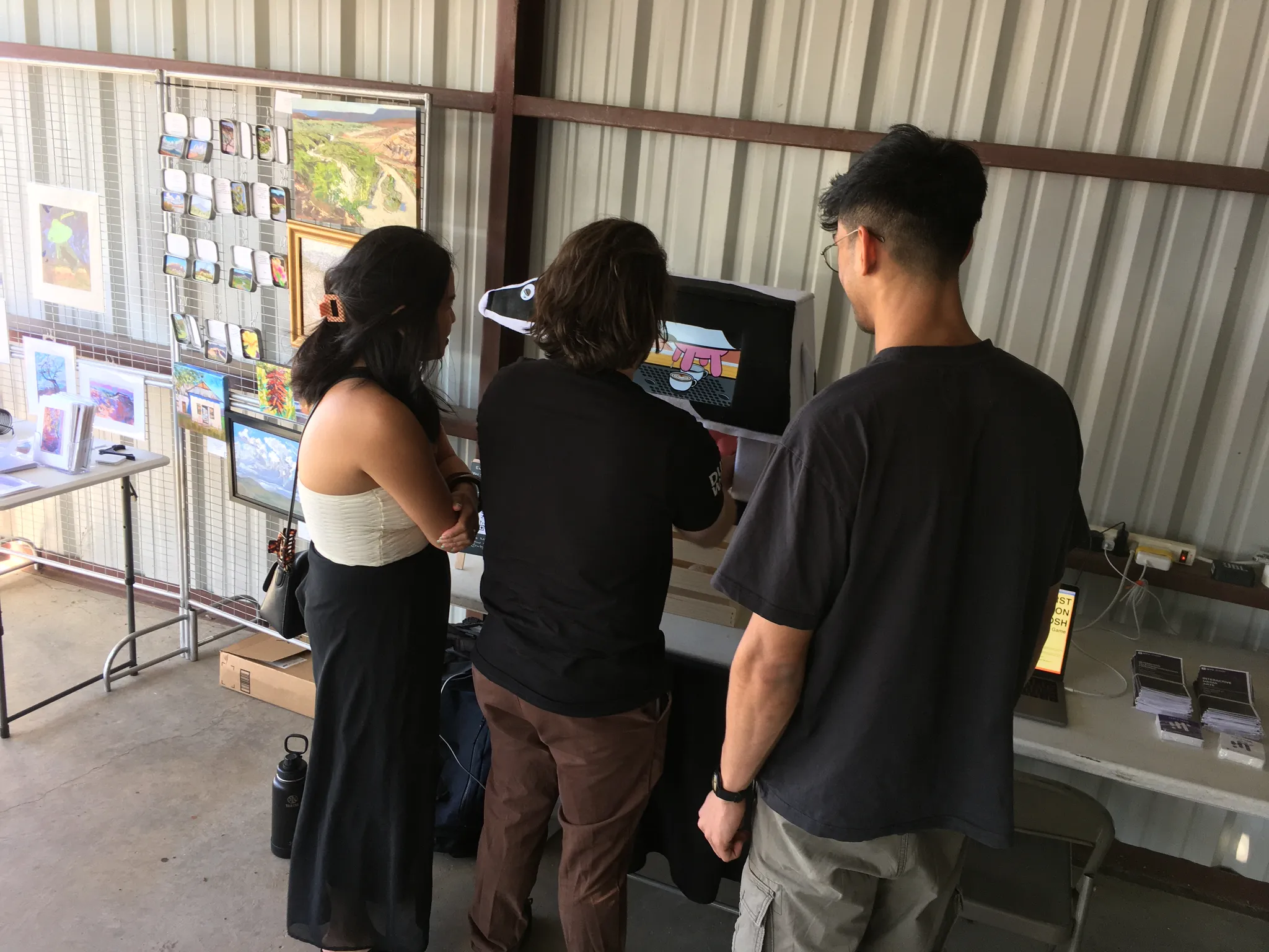 A photograph of a crowd of people standing around a person playing the udder game.