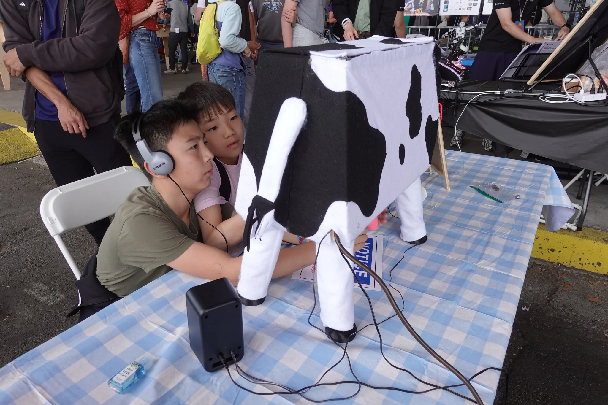 Photograph of the boy who set the high score at the cow, a friend watching over his shoulder