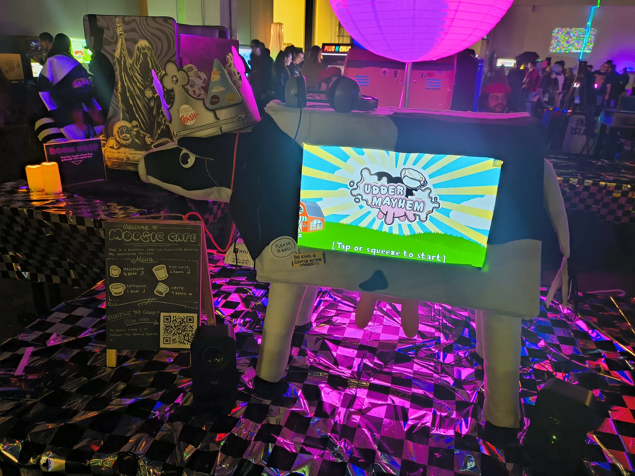 Photograph of Mooriah Dairy glowing under the MAGFest lights with the title screen showing