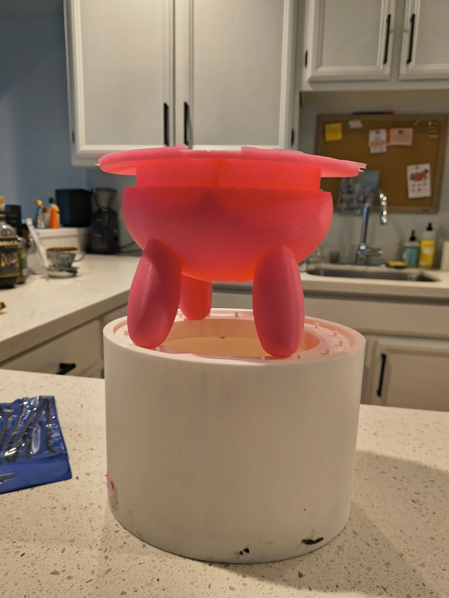 Photograph of a freshly cast pink silicone udder on top of its mold