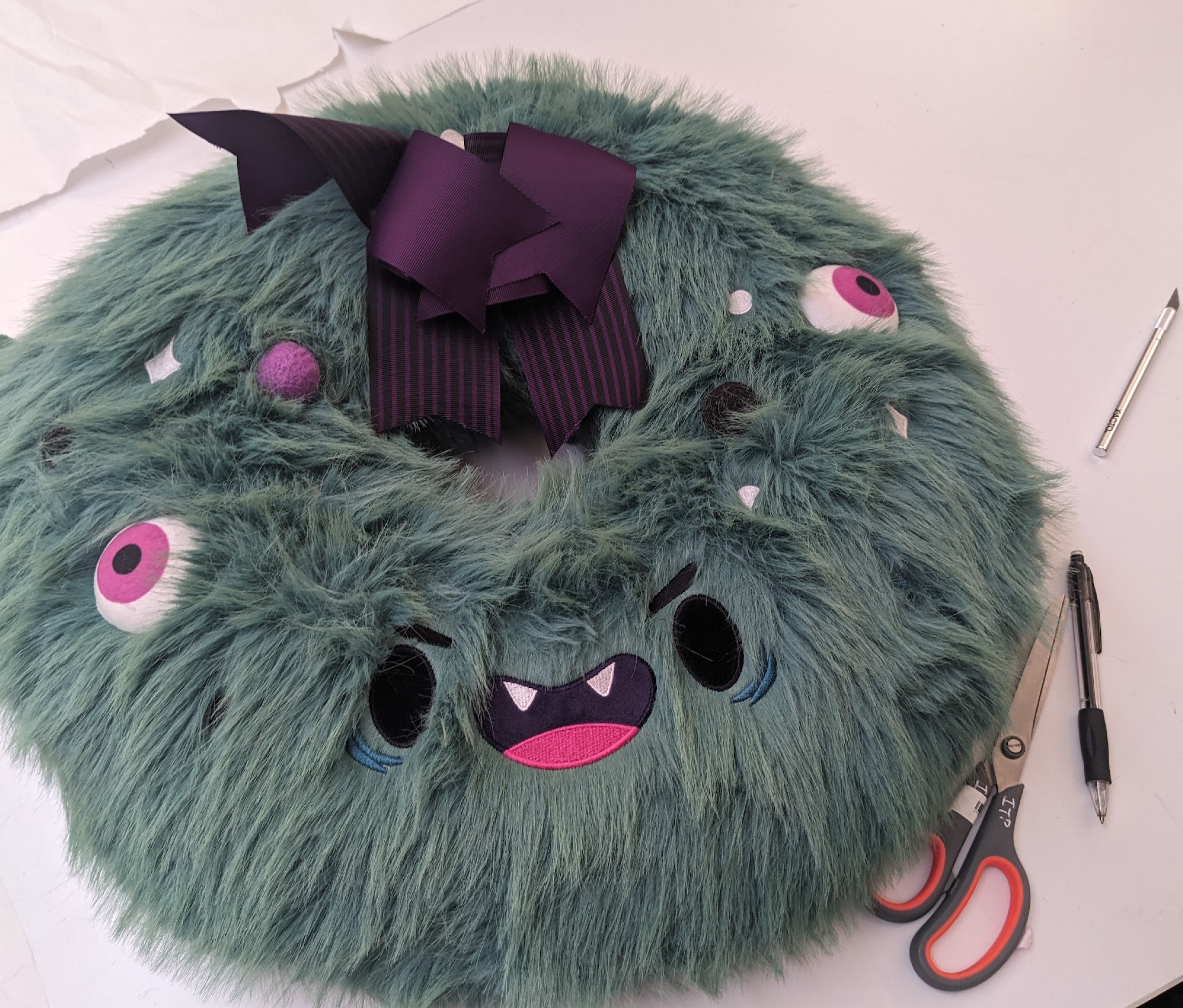 Photograph of a stuffed furry monster wreath