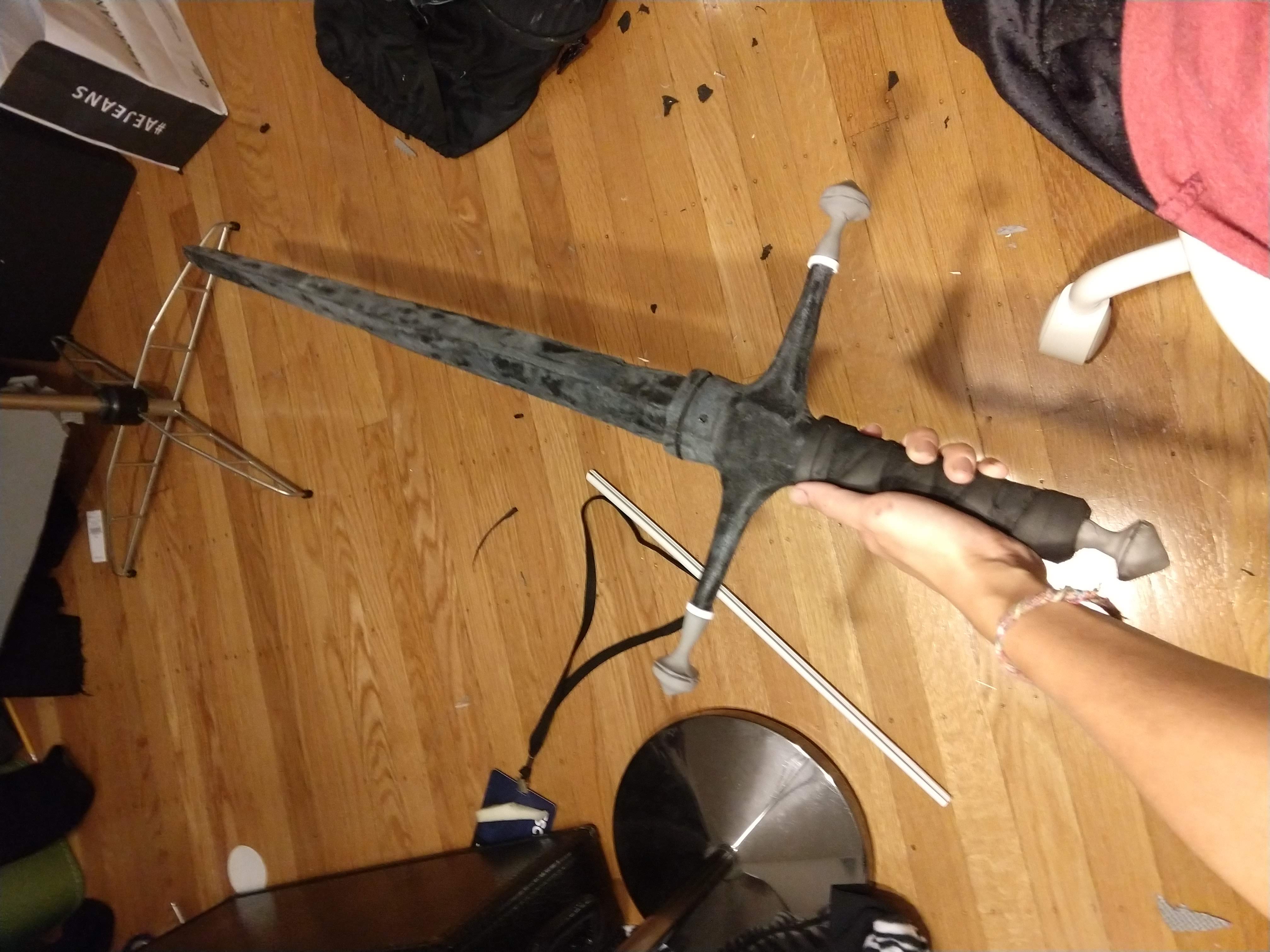 Photograph of a freshly carved foam sword with rough edges covered in worbla