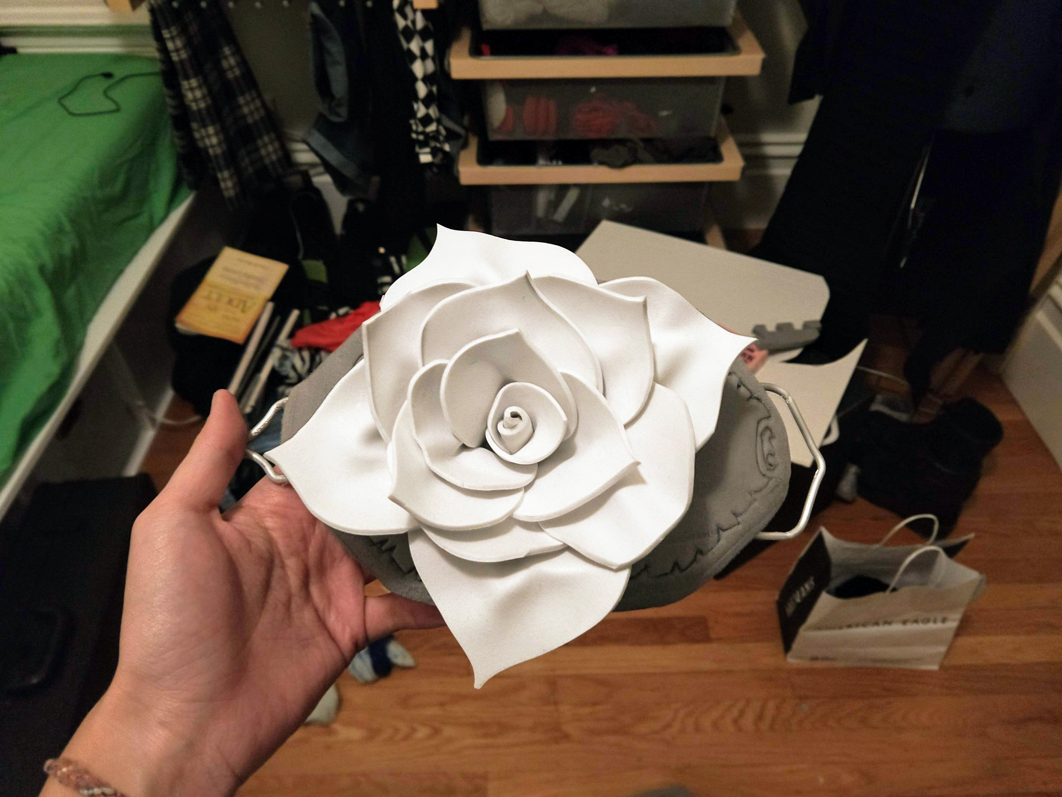 Photograph from the front of a foam rose sitting on top of a foam belt