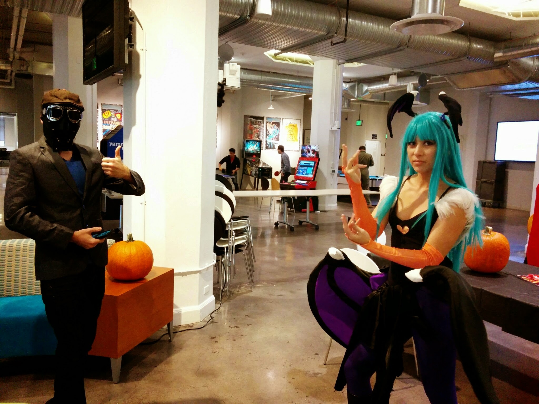 Photograph of a girl wearing a teal wig and a giant set of wings around her waist