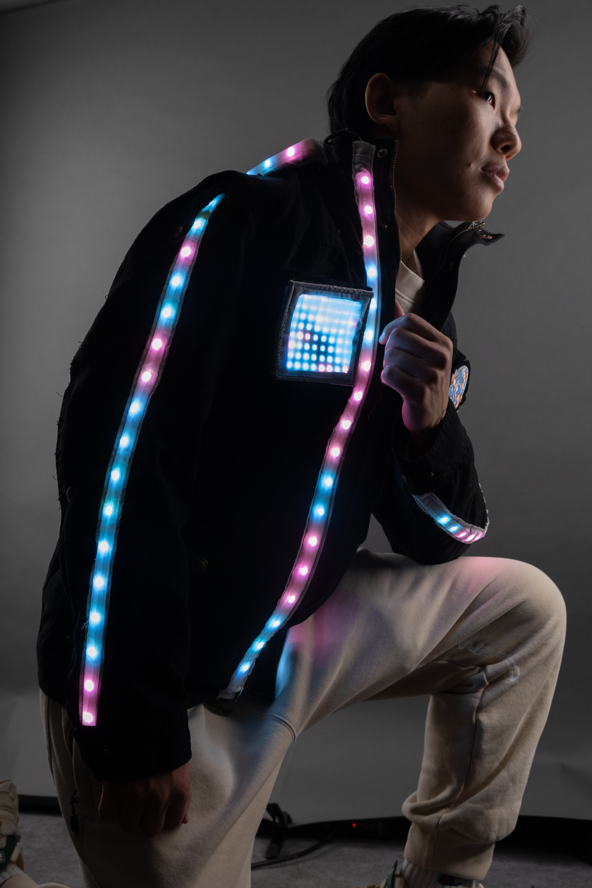 Photograph of a man modeling a light up jacket