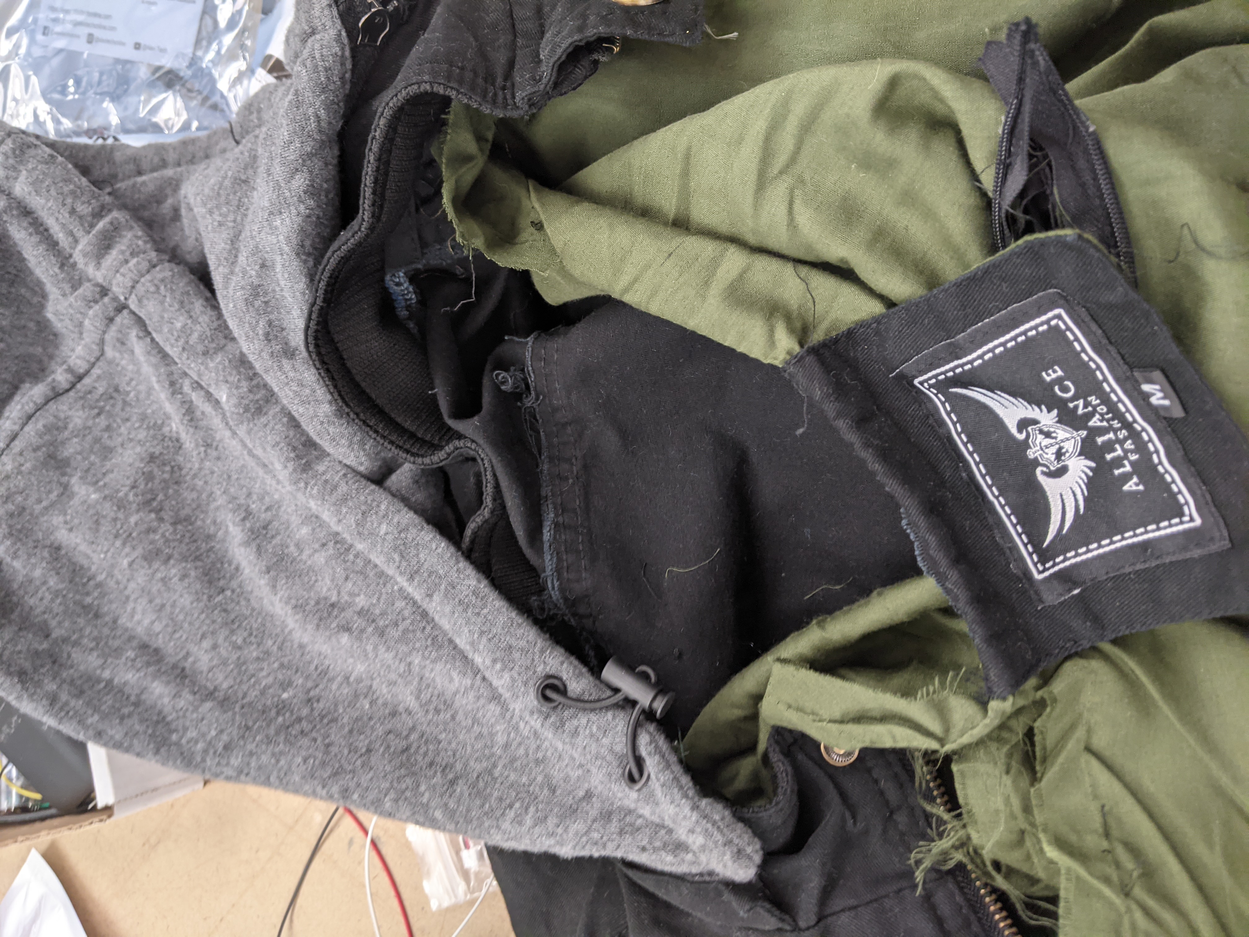 Photograph of a jacket being seam-ripped