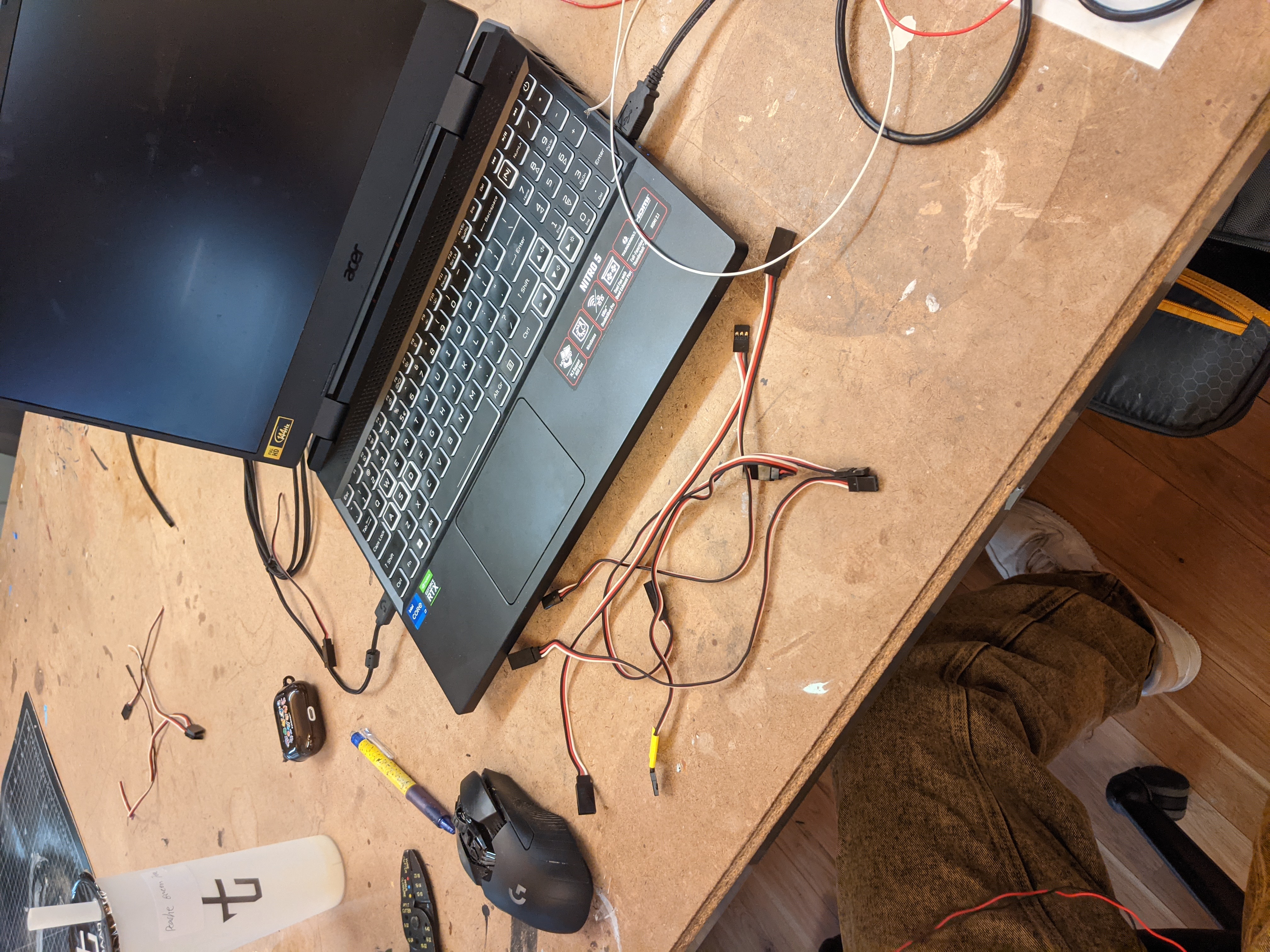 Photograph of a messy desk covered in wires