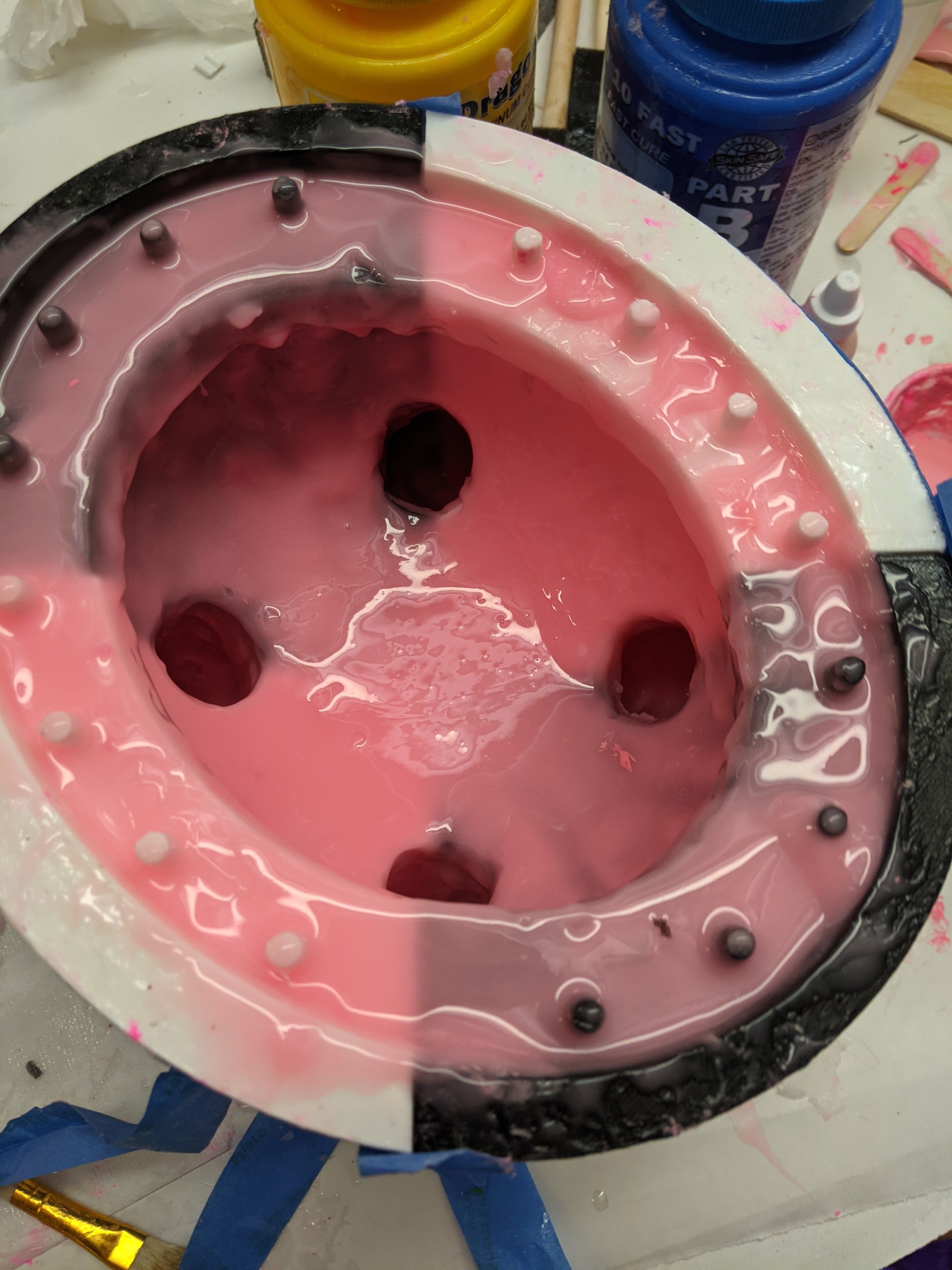 Grotesque photo of the udder mold box coated in gooey pink silicone