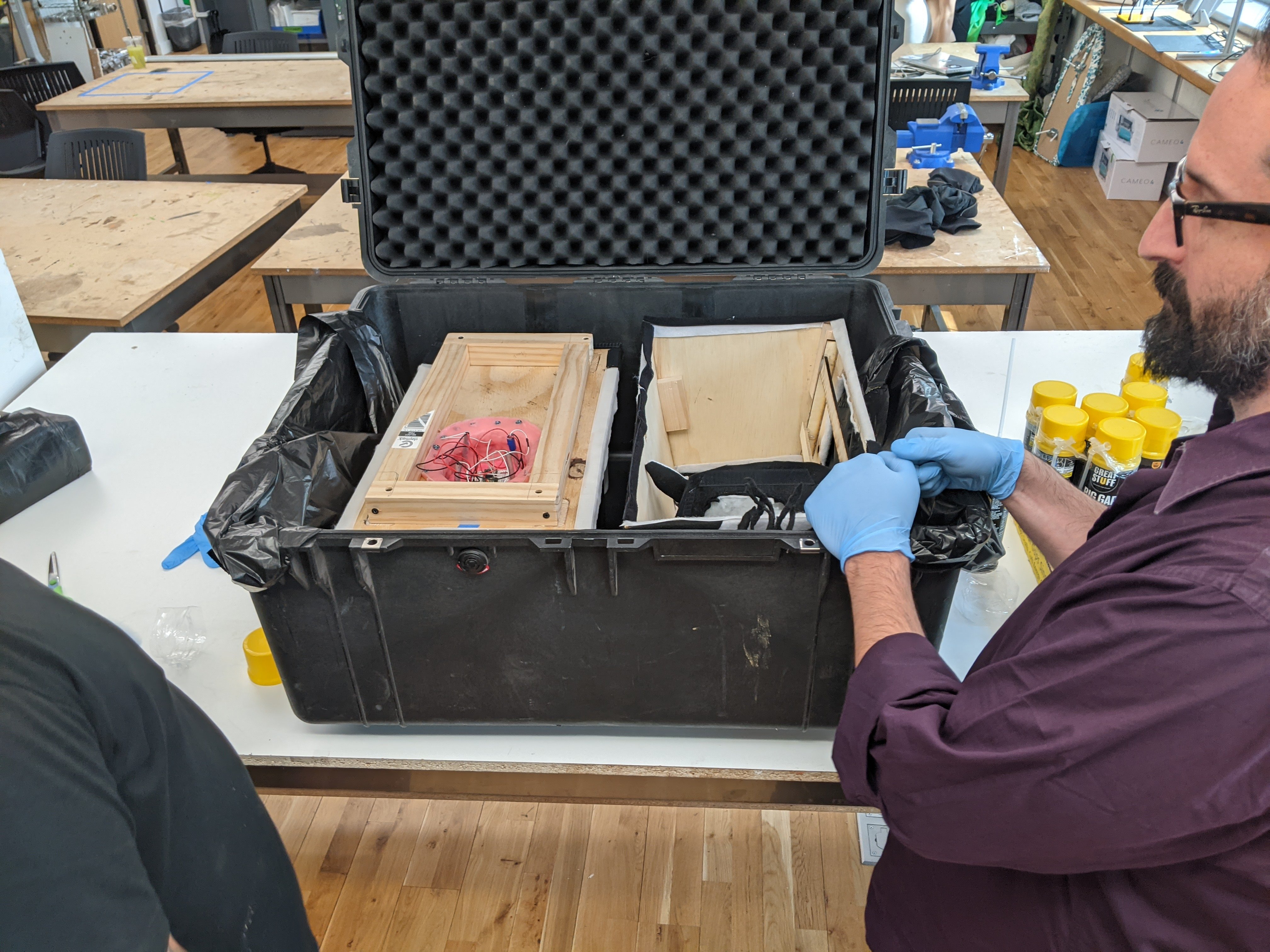 Photograph of stuffing the cow in a Pelican case for shipping