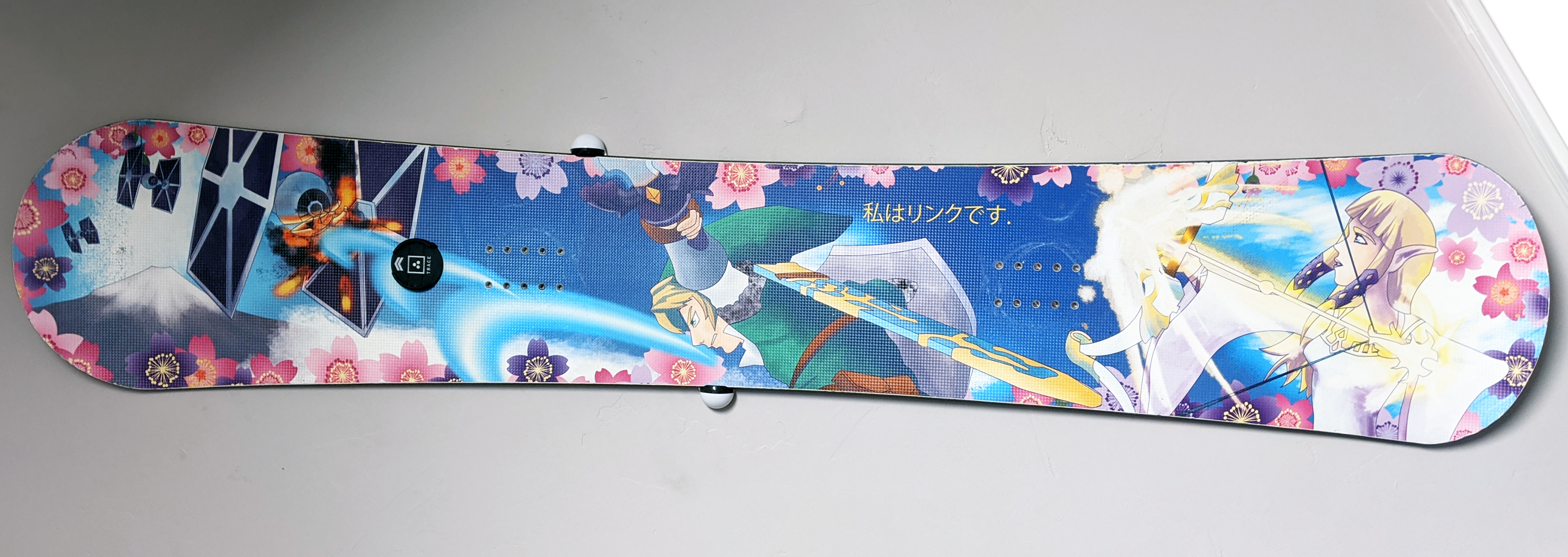 A color illustration of Link attacking tie fighters with his sword and Zelda with her bow with Mt. Fuji in the background and cherry blossom border